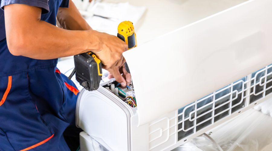 Professional HVAC technicians installing a new outdoor air conditioning system for a residential home in Silver Spring, MD.