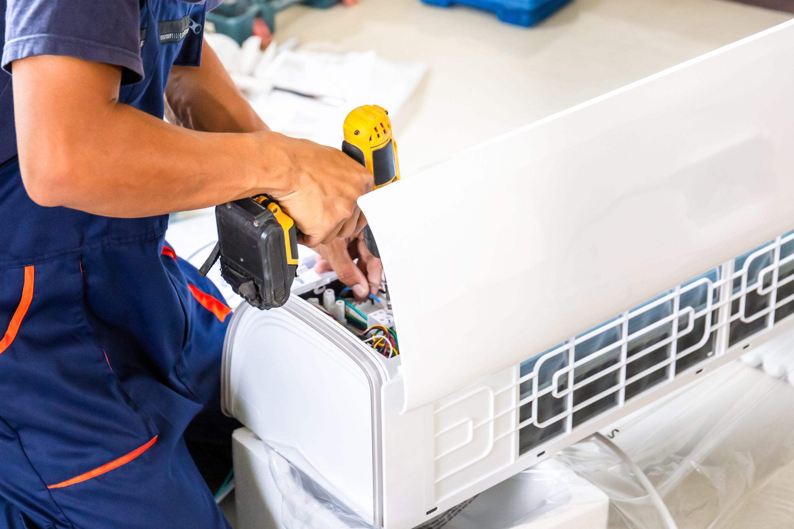 Professional HVAC technicians installing a new outdoor air conditioning system for a residential home in Silver Spring, MD.