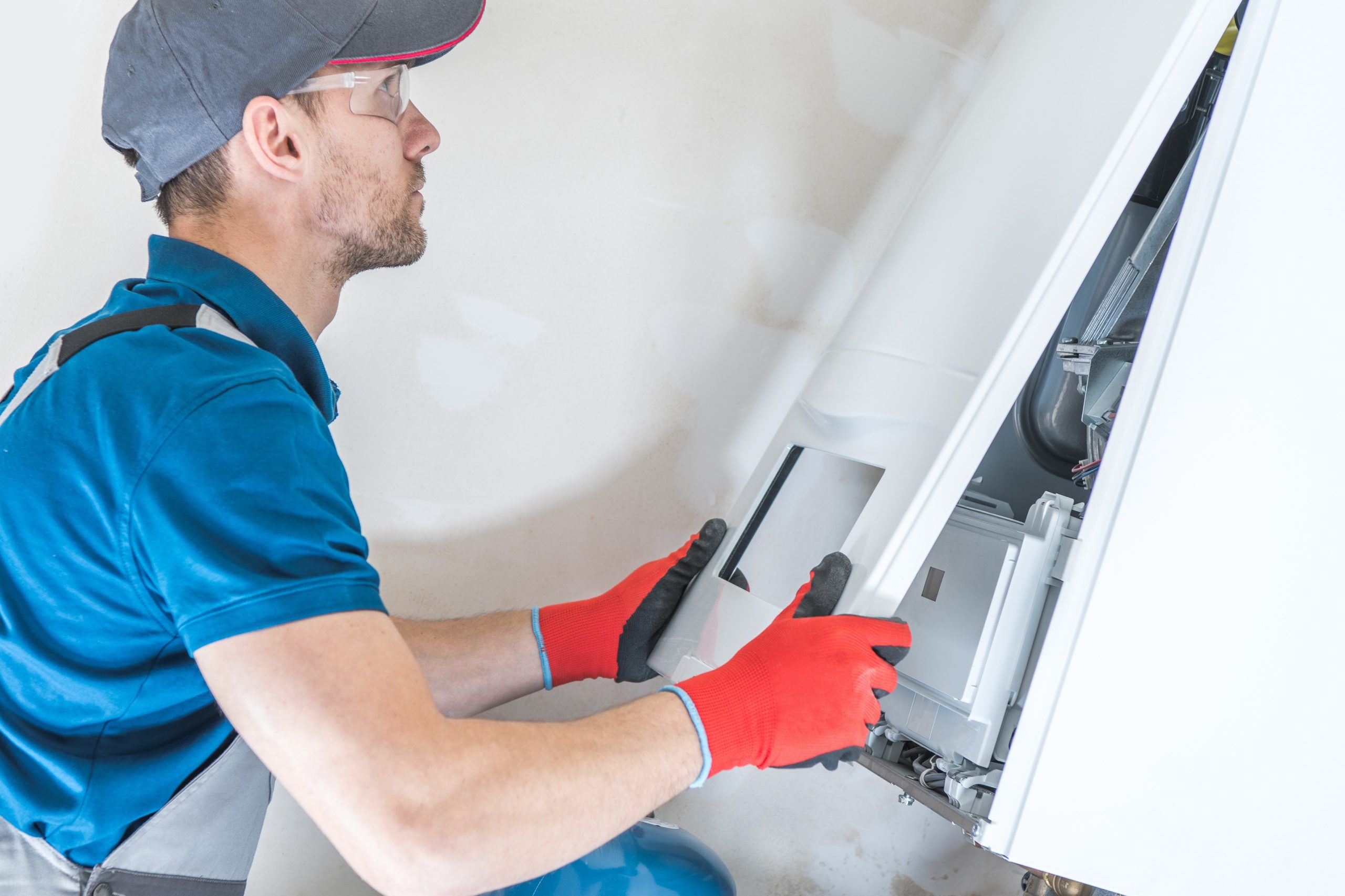 HVAC technician performing furnace repair on a home heating unit in Silver Spring