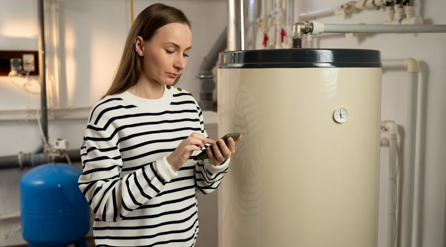 Homeowner inspects furnace in Columbia, MD home, ensuring it’s ready for winter after a Fresh Air Concepts maintenance check.