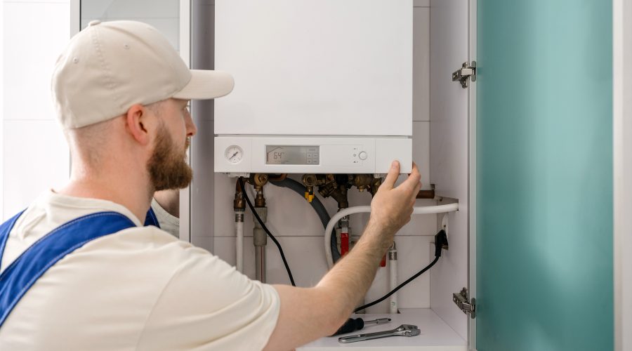 Licensed HVAC technician performing furnace maintenance in Maryland using professional diagnostic tools