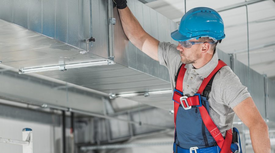 Professional commercial HVAC technician servicing industrial air system in Montgomery County