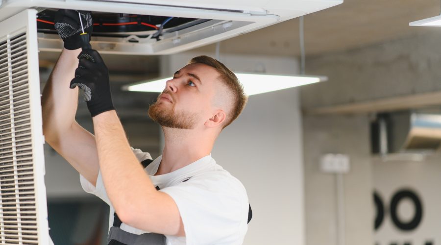 HVAC technician performing preventative maintenance on a residential HVAC ceiling unit in Washington DC