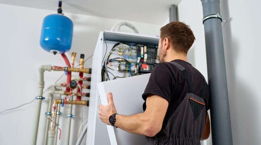 Technician working on indoor heat pump unit for Washington DC home installation