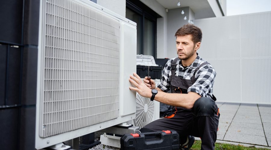 HVAC technician performing heat pump maintenance at a Severna Park home.
