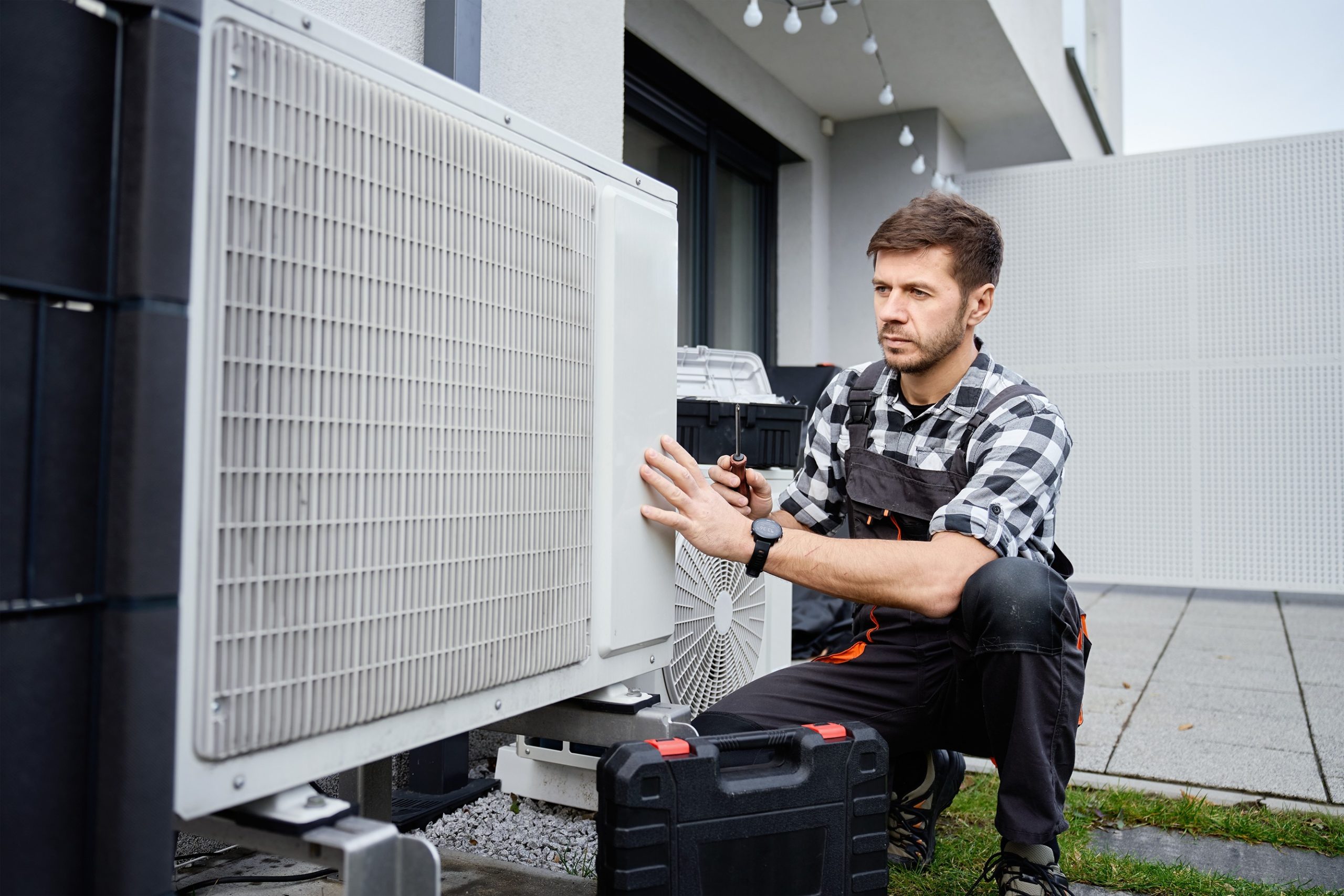 HVAC technician performing heat pump maintenance at a Severna Park home.